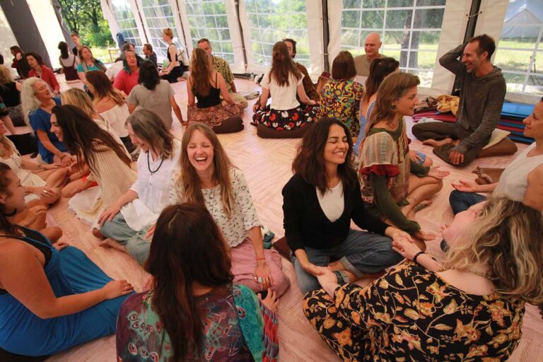 A group breathwork circle in the ASHA tent